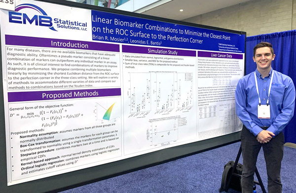 photo of Brian standing next to his poster at DIA 2023.
