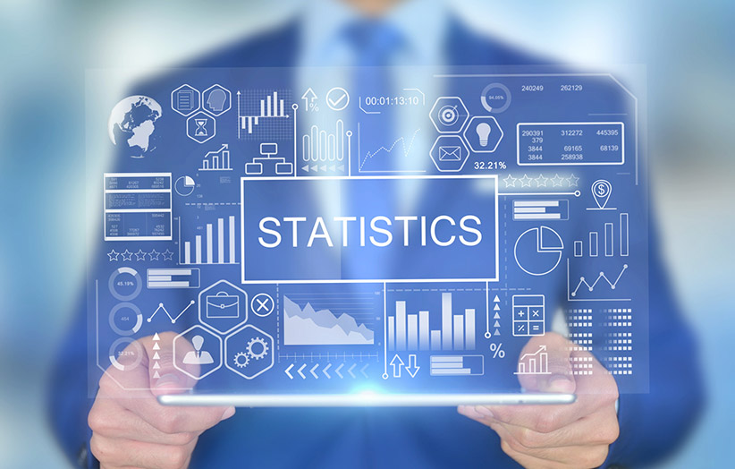 Image of man holding clear display with "Statistics"